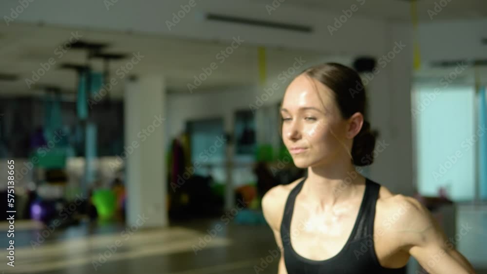 Serious athletic woman punching the air with her fists training warm-up before boxing workout at home interior. Sports. Activity. Motivation. Confidence Serious athletic woman punching the air with her fists training warm-up before boxing workout at home interior. Sports. Activity. Motivation. Confidence