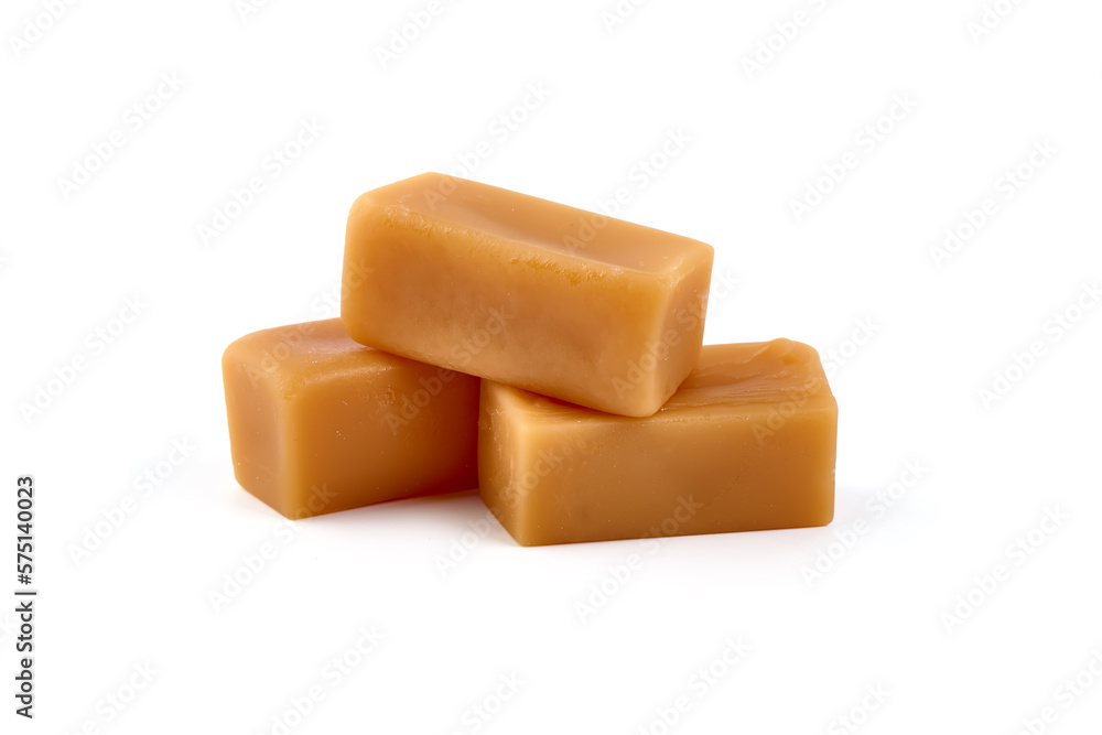 Caramel candies with caramel sauce, isolated on white background. Caramel candies with caramel sauce, isolated on white background.