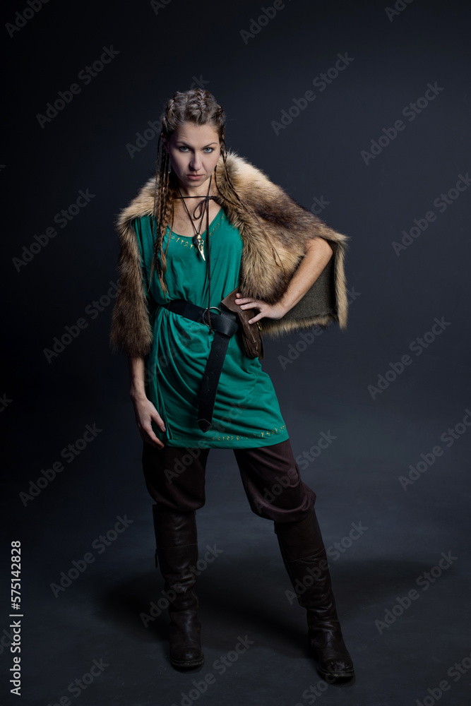 A Viking warrior woman in a fur cape. portrait on a black background