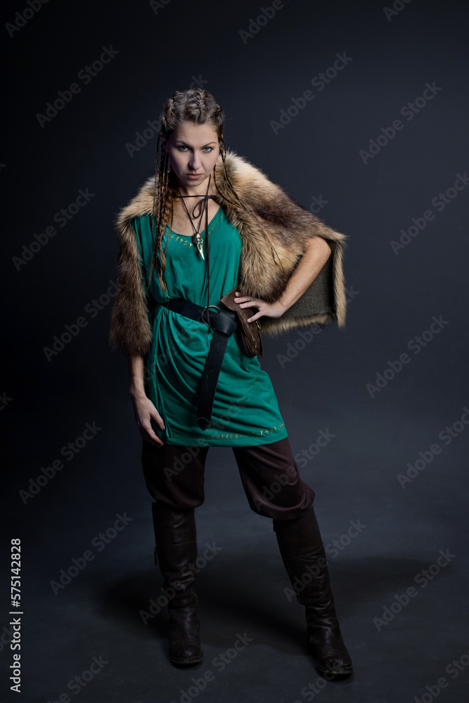 A Viking warrior woman in a fur cape. portrait on a black background A Viking warrior woman in a fur cape. portrait on a black background