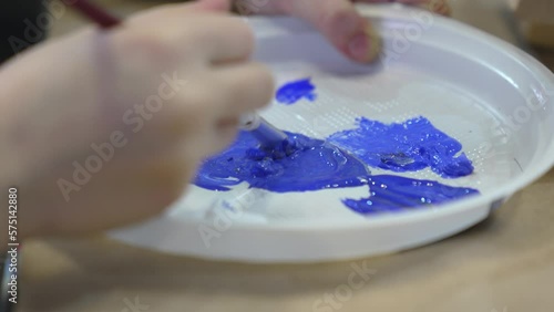 Disposable plastic plate as a palette for acrylic paints.  photo