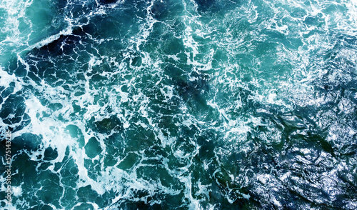 Aerial view of the ocean water surface and waves. Beautiful water background texture for tourism and advertising. Tropical coast