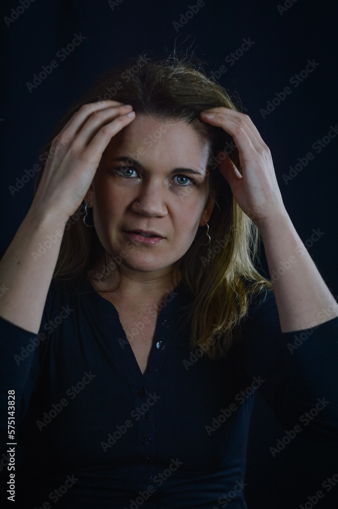 portrait of a beautiful blonde woman who with her hands on her temples concentrates to take stock of the situation portrait of a beautiful blonde woman who with her hands on her temples concentrates to take stock of the situation