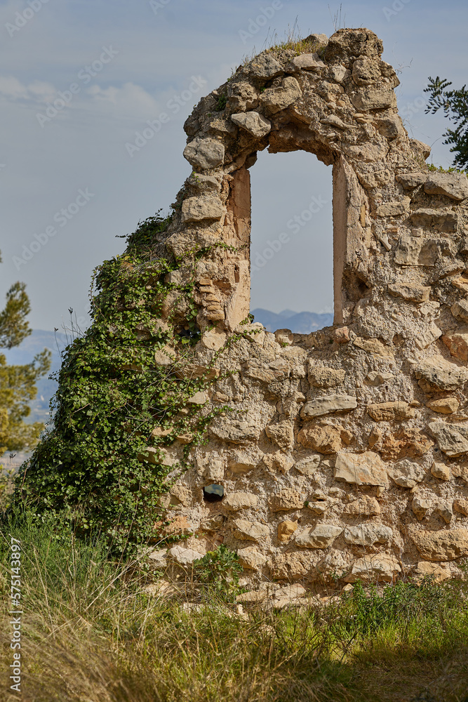 Ruined walls of an ancient castle with a window on a rock Ruined walls of an ancient castle with a window on a rock
