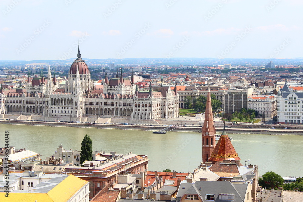Beautiful view of Budapest, Hungary on a sunny day. The river and the parliament can be seen, together with some towers. The sky is blue and there are no clouds.
