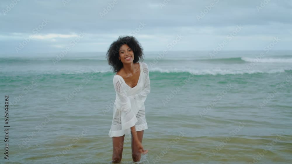 Smiling girl enjoying ocean waves in bikini. Happy woman having fun at sea shore Smiling girl enjoying ocean waves in bikini. Happy woman having fun at sea shore