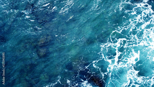 Stampa su tela Aerial view of the ocean water surface and waves