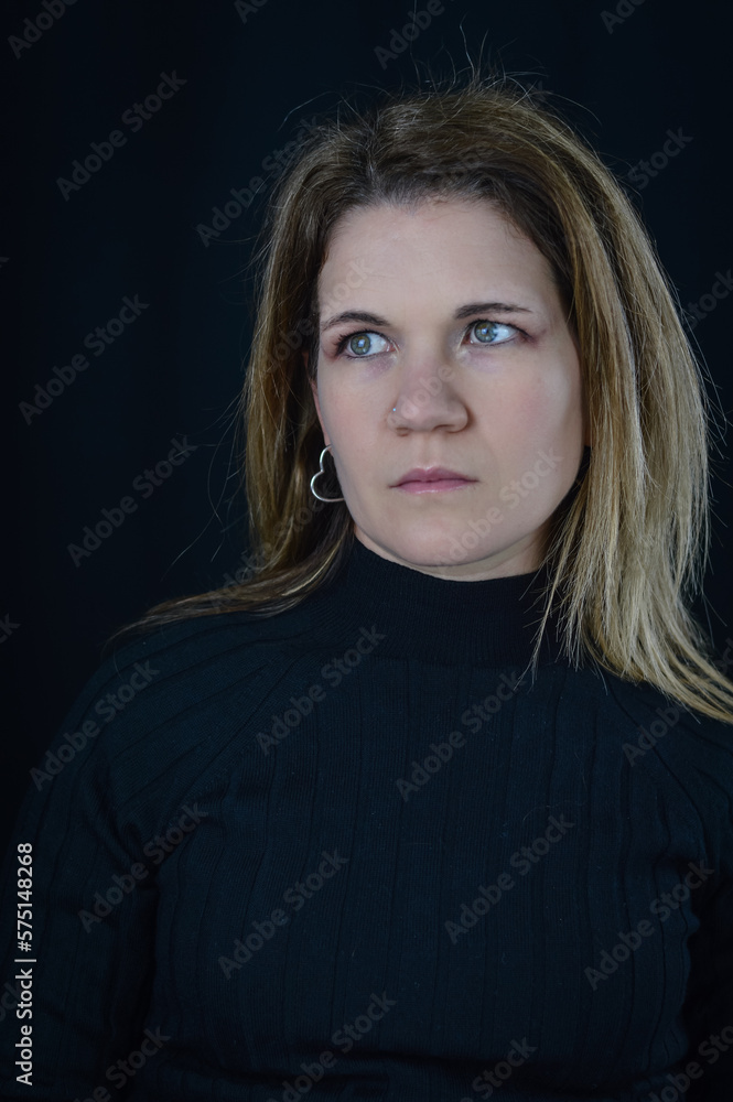 portrait of a beautiful blonde woman with a very sad look who looks away in space portrait of a beautiful blonde woman with a very sad look who looks away in space