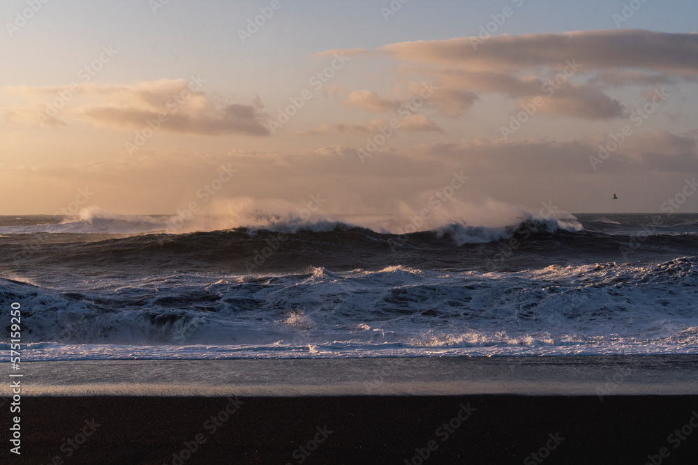 Black beach Iceland big ocean waves during sunrise