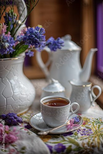 still life with geocinches, tea drinking near the window with a bouquet of spring flowers. beautiful floral background, art design, colorful bouquets.