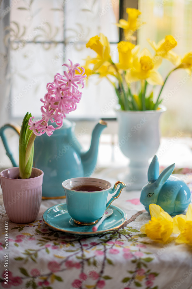 still life with hyacinth and daffodils, tea drinking near the window with a bouquet of spring flowers. beautiful floral background, art design, colorful bouquets.