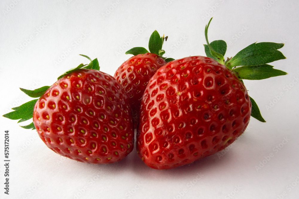 three strawberries on white background three strawberries on white background