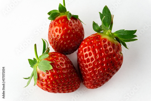 three strawberries isolated on white background
