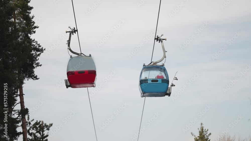 New modern spacious big cabin ski lift gondola against snowcapped forest tree and mountain peaks covered in snow landscape in luxury winter alpine resort. Winter leisure sports, recreation New modern spacious big cabin ski lift gondola against snowcapped forest tree and mountain peaks covered in snow landscape in luxury winter alpine resort. Winter leisure sports, recreation