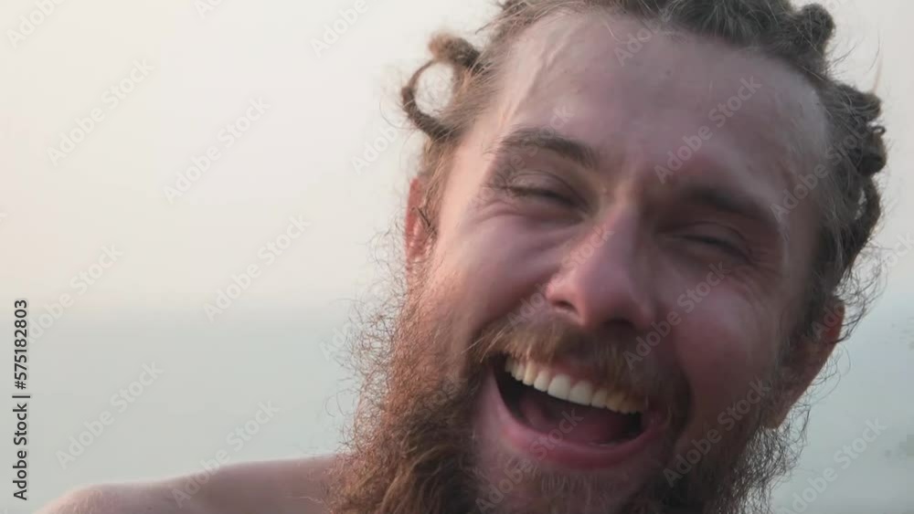 A man with a big beard and an expression of joy, smiling broadly A man with a big beard and an expression of joy, smiling broadly