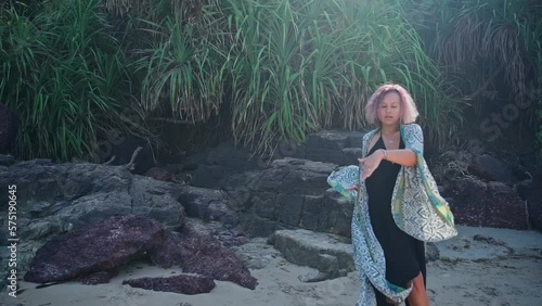 A young girl with purple hair dances on a slow-motion recording. Slow motion.