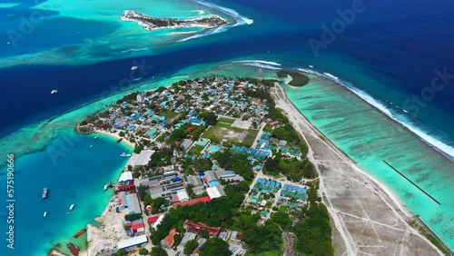 Aerial Panning Beautiful View Of Structures On Island In Sea, Drone Flying During Sunny Day - Thulusdhoo, Maldives photo