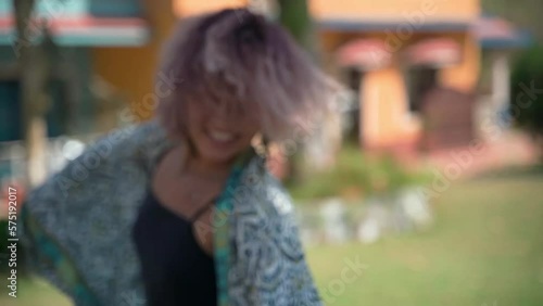 A girl of European appearance enthusiastically dances in a dress
