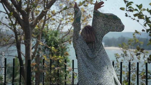 A girl of European appearance with short hair dances to the rhythm of music