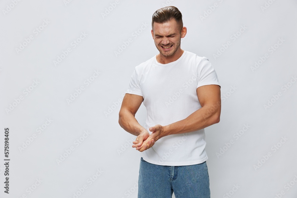 Man arm pain, sprain and muscle injury in white T-shirt on white isolated background, copy space Man arm pain, sprain and muscle injury in white T-shirt on white isolated background, copy space