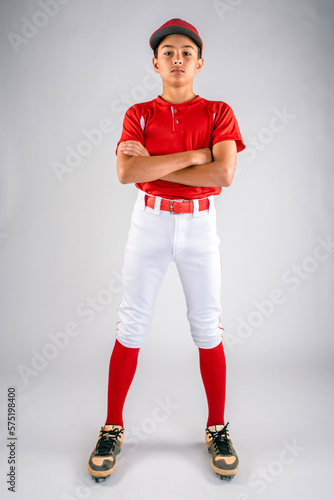 Canvas Print Male youth baseball player standing with folded arms