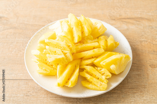 fresh pineapple sliced on plate