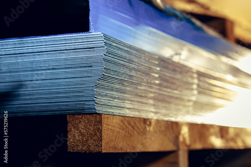 Sheets of metal in a stack in a warehouse