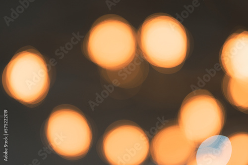 Yellow bokeh circles on a faded black background