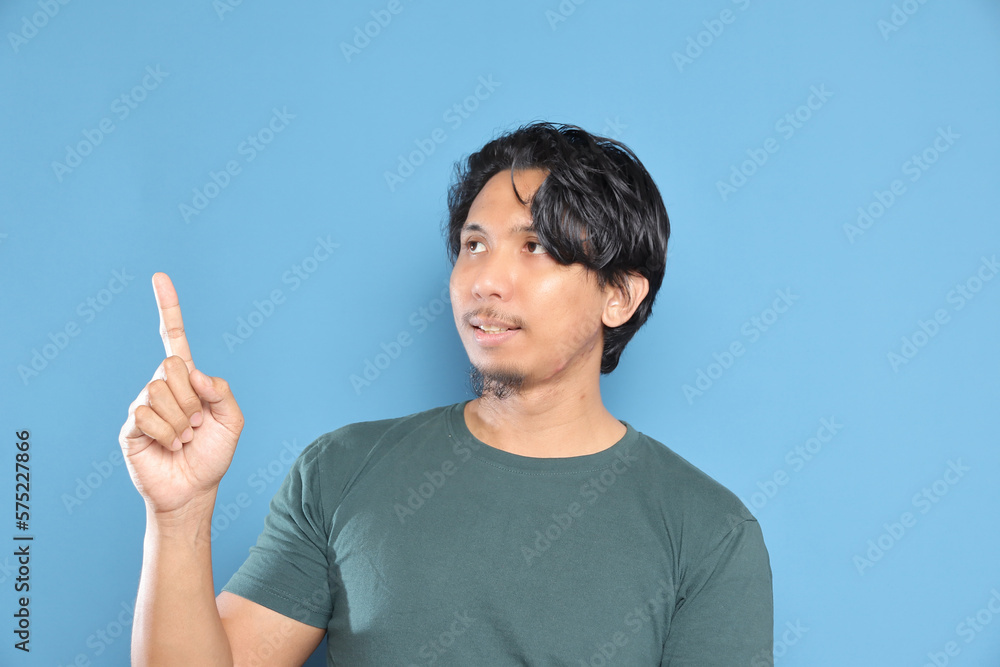 Asian male holding a measuring tape over isolated studio background. Asian male holding a measuring tape over isolated studio background.