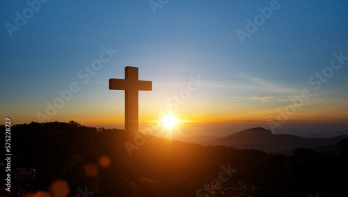 Silhouettes of Christian cross symbol on top mountain at sunrise sky background. Concept of Crucifixion Of Jesus Christ.