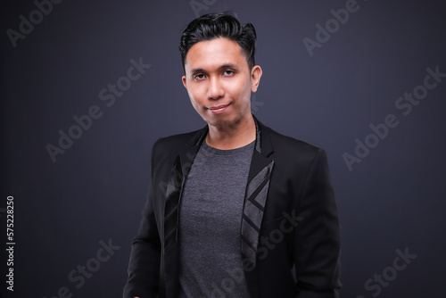 Asian male in corporate oufit over dark background.  Office business concept. photo