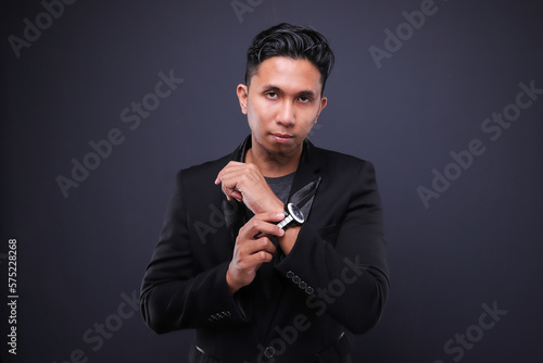 Asian male in corporate oufit over dark background.  Office business concept. photo