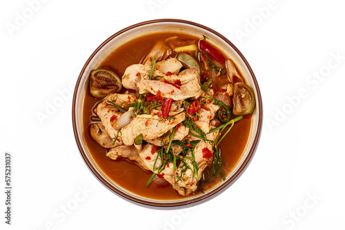 Top view of Thai Pork curry with Dill isolated on white background. That is local food of Isan in Thailand. This menu contains many vegetables such as dill, brinjal, chilli, lemongrass and red onions.