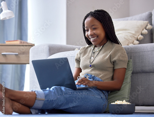 Relax, black woman on floor and laptop for movies, happiness and girl in living room. African American female, lady and device for streaming shows, funny videos or search internet in lounge on ground