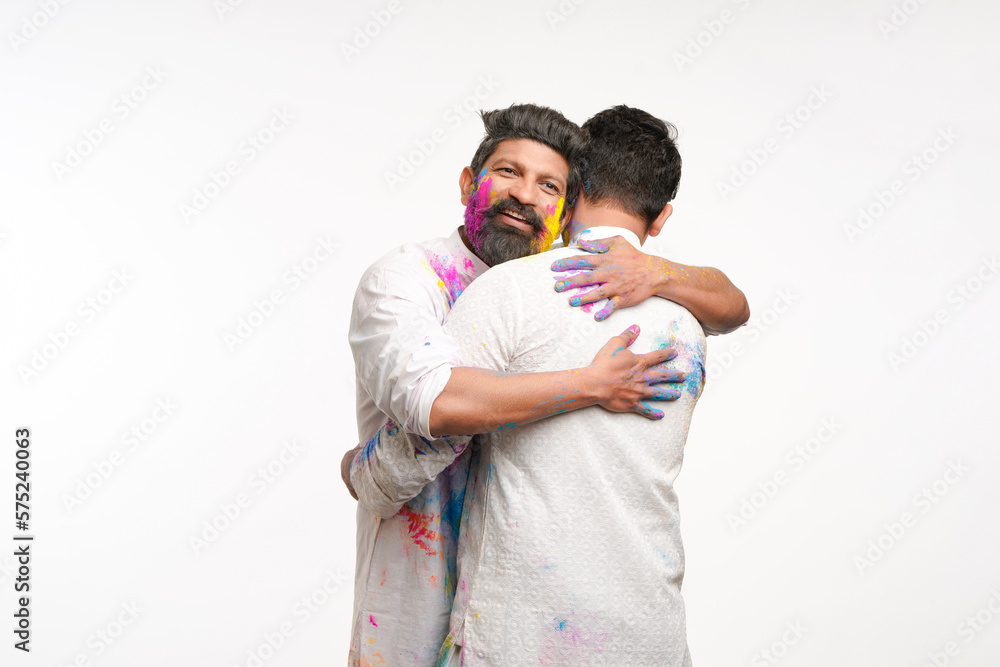 Indian man hugging to each other and wishing holi festival Indian man hugging to each other and wishing holi festival