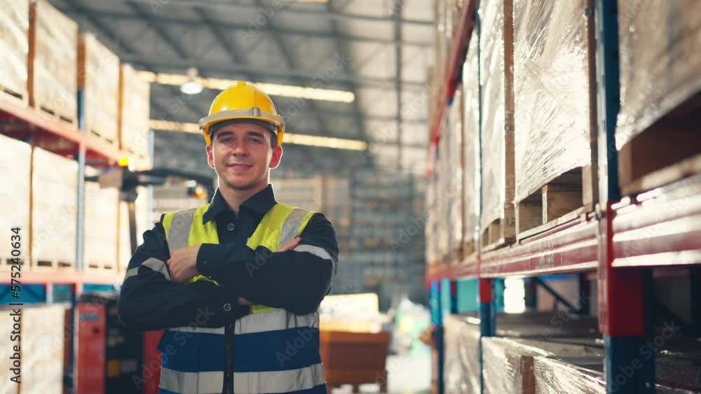 Happy professional worker looking at camera and smiling in the background warehouse with shelves full of delivery goods. Logistics, Delivery, and Distribution center. Happy professional worker looking at camera and smiling in the background warehouse with shelves full of delivery goods. Logistics, Delivery, and Distribution center.