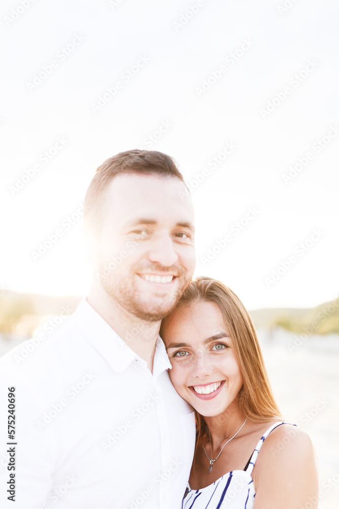 man and a woman are hugging on a sandy beach in summer man and a woman are hugging on a sandy beach in summer