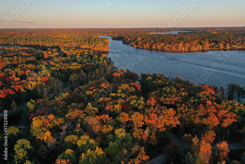 Fototapeta Naklejka Na Ścianę i Meble -  Boats in lake as sun sets on fall season in Wisconsin