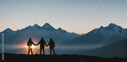 Silhouette of two person on top of mountain peak. / Holding Hands / coaching goal, success and teamwork concepts - Mountains Mountaineer / Space for Text / Blank Space / Copy Text
