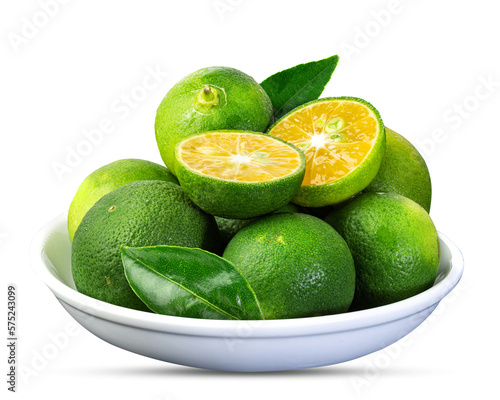 Green Cumquat or Kumquat fruits with leaves in a ceramic bowl isolated on a white background