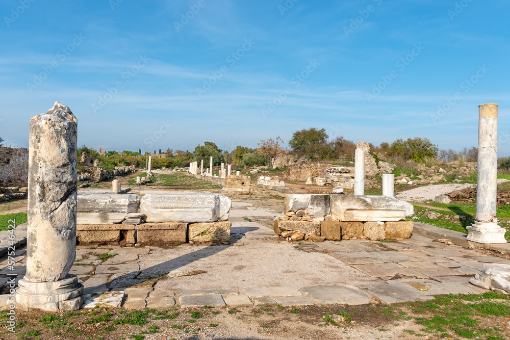 Panorama of the old roman road with columns in the ancient town Side at sunny day. Оne of the most attractive cultural tourism showplace in Side (Turkey).