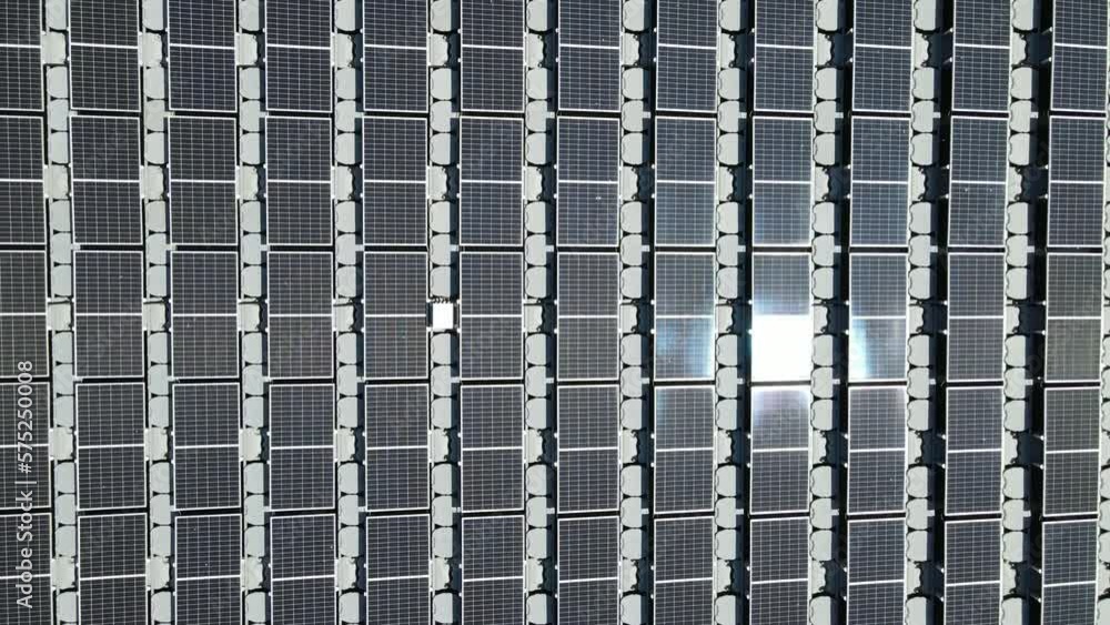 Aerial top view of solar panels or solar cells on buoy floating in lake sea or ocean. Power plant with water, renewable energy source. Aerial top view of solar panels or solar cells on buoy floating in lake sea or ocean. Power plant with water, renewable energy source.