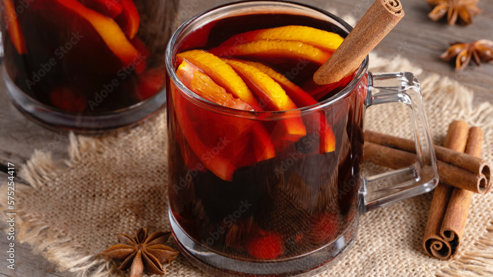 Mulled wine in glass mugs with spices and citrus fruit Mulled wine in glass mugs with spices and citrus fruit