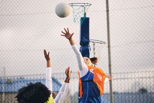Fotografie Netball, goal shooting and defense of a girl athlete group on an outdoor sports court