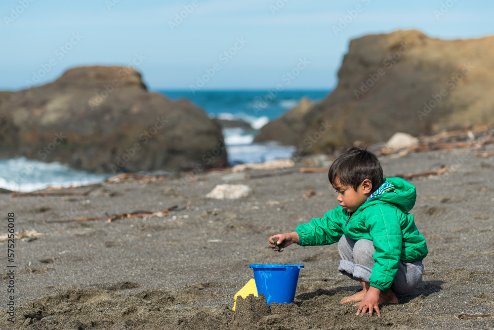 Young Asian boy playing on beach along the California Coast Young Asian boy playing on beach along the California Coast