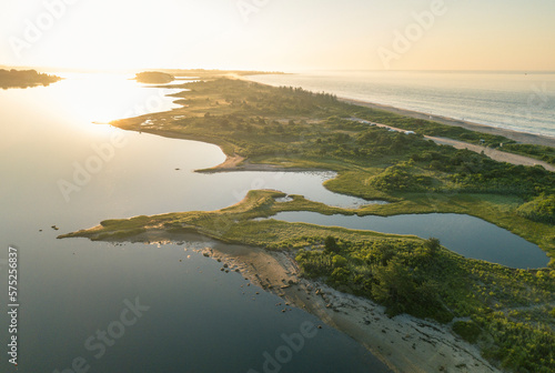 Aerial view of beach dividing Quonochontaug Pond and Atlantic Ocean at sunrise, Weekapaug, Westerly, Rhode Island, USA