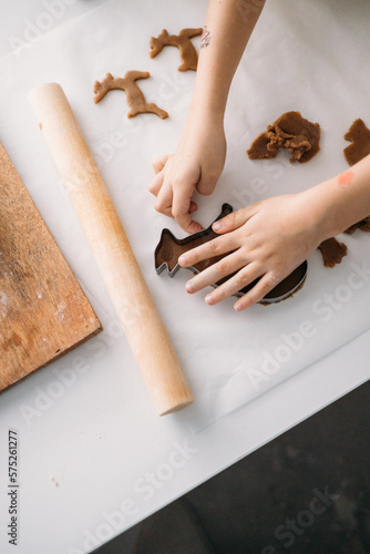 child preparing gingerbread. girl child is preparing Christmas sweets