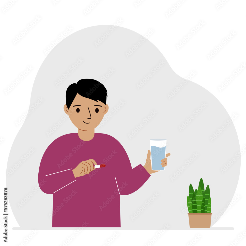 A little boy in one hand holds medicine or a pill in another glass of water. The concept of taking medicine to treat diseases, taking vitamins or food supplements with water. A little boy in one hand holds medicine or a pill in another glass of water. The concept of taking medicine to treat diseases, taking vitamins or food supplements with water.