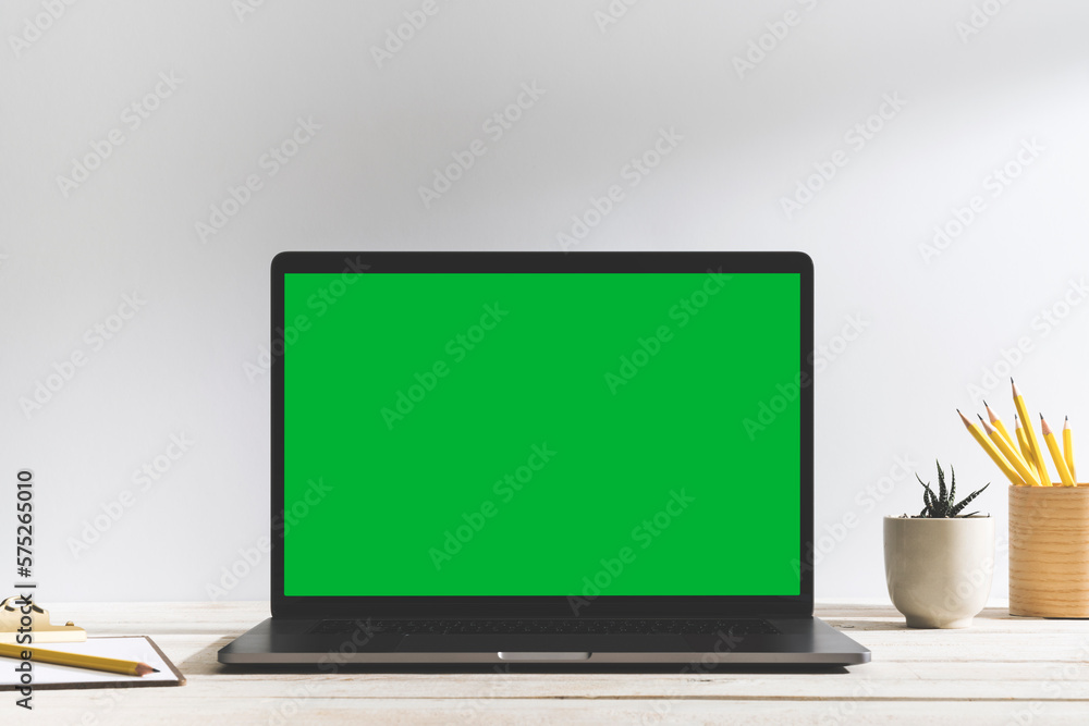 Chroma key green screen laptop on table with white background. Stock ...