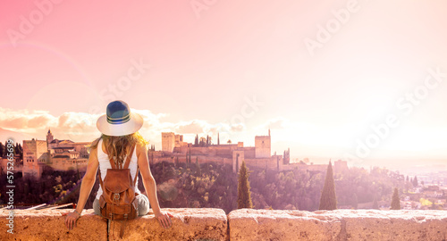 Tourist looking at  Ancient arabic fortress Alhambra in Granada at sunset- Spain